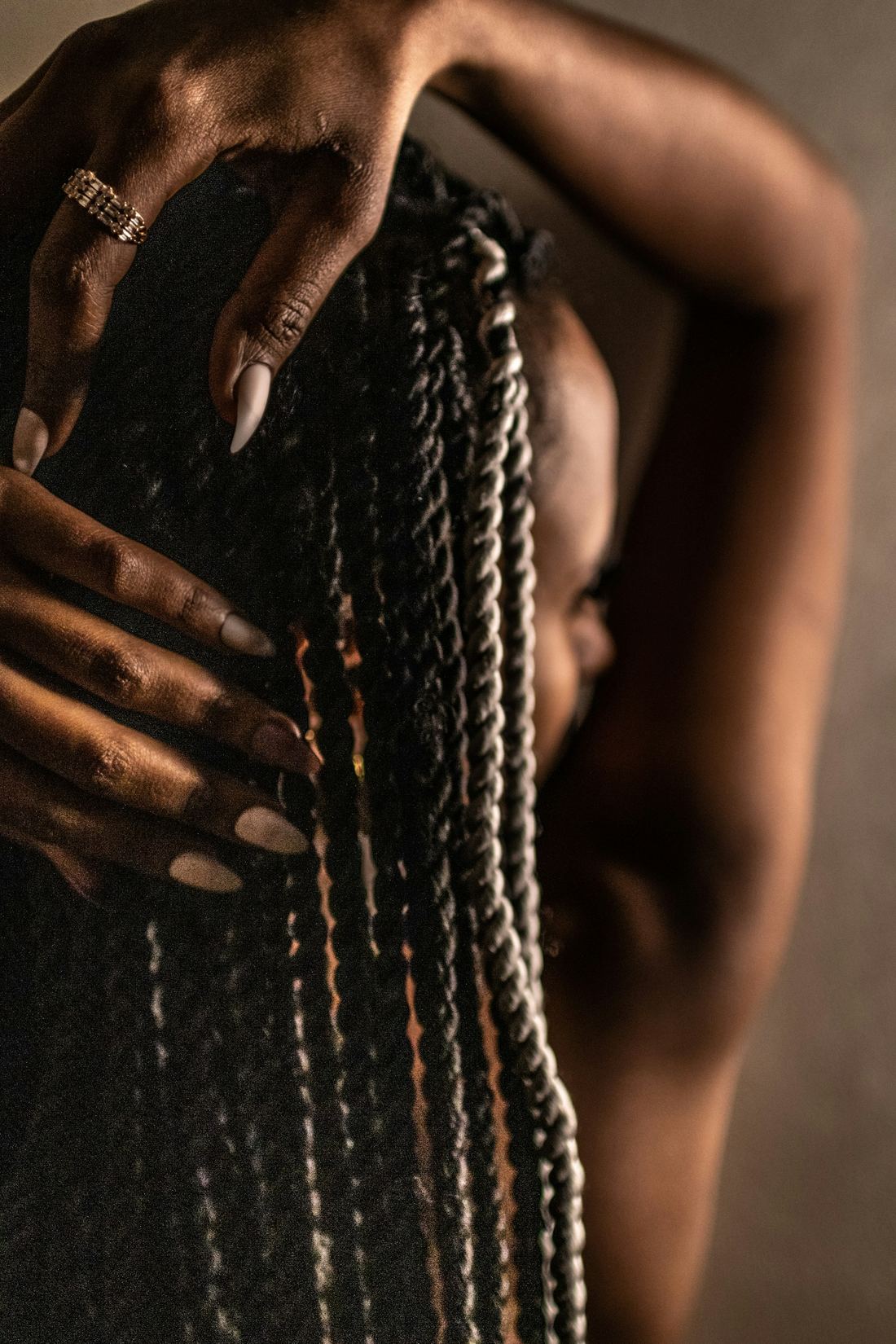 Hands resting in long braids (sample photo)